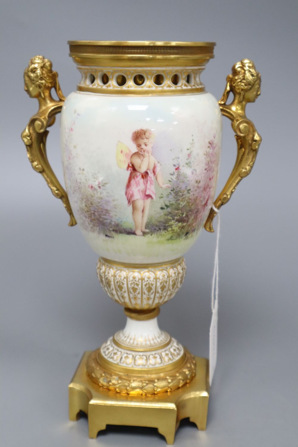 A French painted porcelain and gilt metal two-handled vase, signed I Marchand, height 23.5cm (lacking cover),